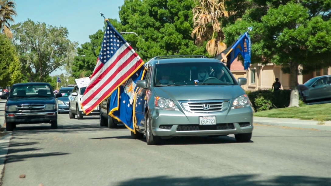 A vehicle rolls down a neighborhood street during the “Purple Up for Military Kids” car parade at Edwards Air Force Base, California, April 24. The parade was conducted to show appreciation and support for the base's children population. (Courtesy photo)