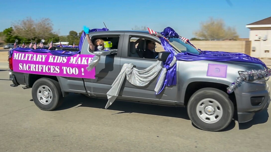 A vehicle rolls down a neighborhood street during the “Purple Up for Military Kids” car parade at Edwards Air Force Base, California, April 24. The parade was conducted to show appreciation and support for the base's children population. (Courtesy photo)