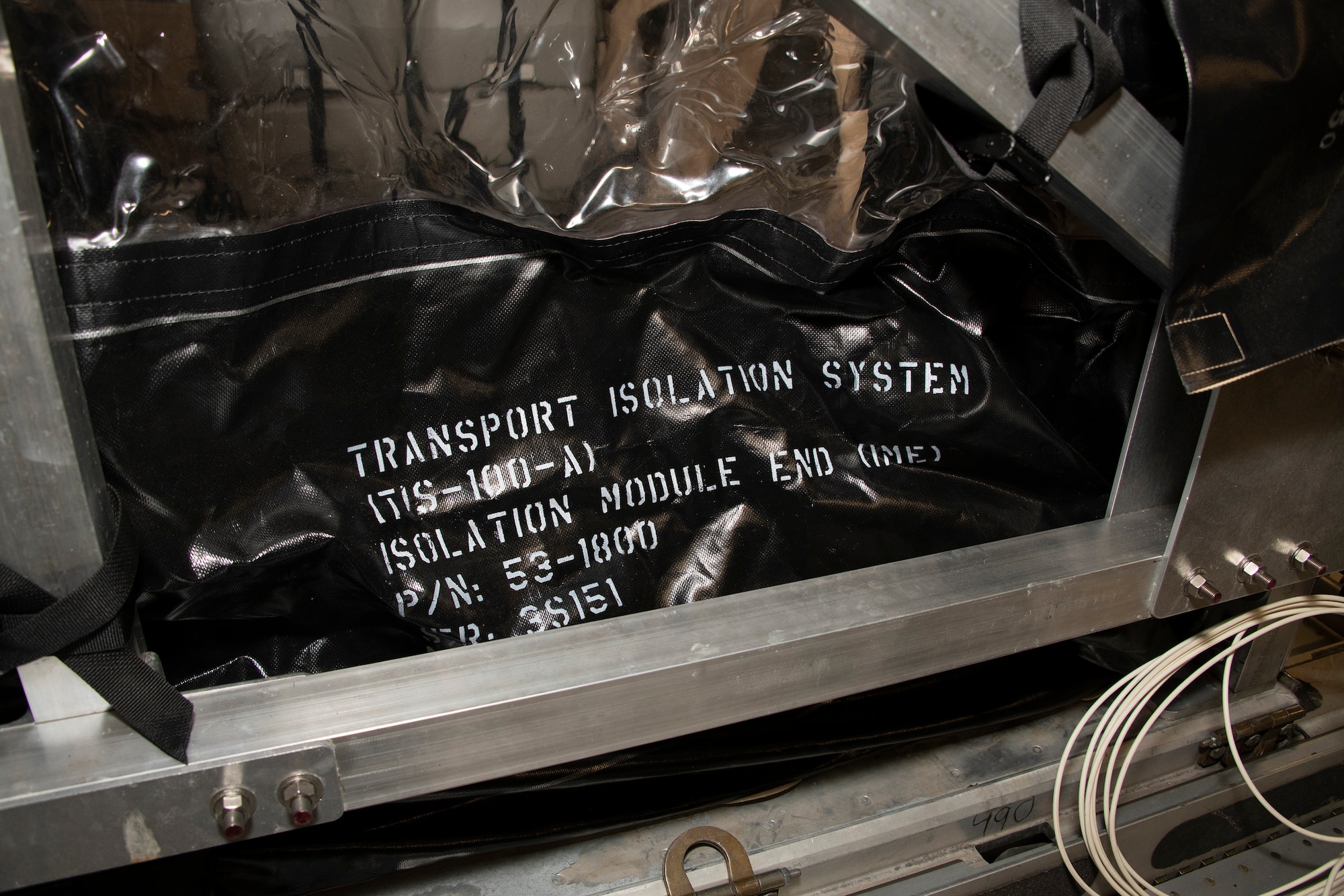 A Transport Isolation System capsule sits in the cargo bay of a C-17 Globemaster III May 9, 2020, at Travis Air Force Base, California. The C-17, C-130H Hercules and C-130J Super Hercules are the only aircraft capable of carrying TIS capsules, which the DOD initially engineered in response to the Ebola virus in 2014. The capsules allow the transport of individuals with highly contagious diseases without infecting any other passengers or aircrew on the aircraft. (U.S. Air Force photo by Heide Couch)