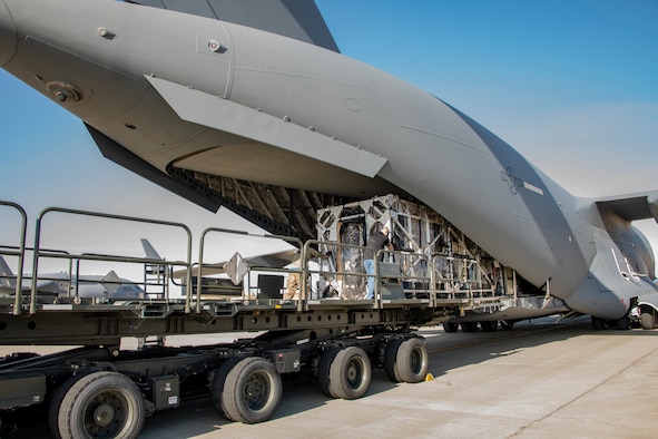Personnel from the 60th Aerial Port Squadron transfer a Transport Isolation System capsule from a Tunner 60K loader into the cargo bay of a C-17 Globemaster III May 9, 2020, at Travis Air Force Base, California. The C-17, C-130H Hercules and C-130J Super Hercules are the only aircraft capable of carrying TIS capsules, which the DOD initially engineered in response to the Ebola virus in 2014. The capsules allow the transport of individuals with highly contagious diseases without infecting any other passengers or aircrew on the aircraft. (U.S. Air Force photo by Heide Couch)