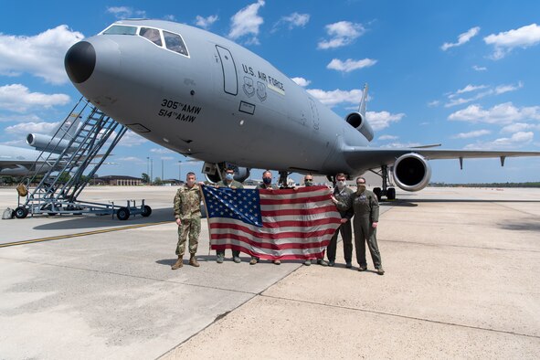 Members with the 76th and 78th Air Refueling Squadron, 514th Air Mobility Wing, Joint Base McGuire-Dix-Lakehurst, N.J., pose for a group photo in front of a KC-10 Extender on May 13, 2020 at JB MDL. The 514th performed their scheduled refuel missions in tandem with an #AmericaStrong flyover saluting and thanking all healthcare workers, first responders, and other essential personnel serving on the front lines of the fight against COVID-19. (U.S. Air Force photo by Tech. Sgt. Michael Hong)