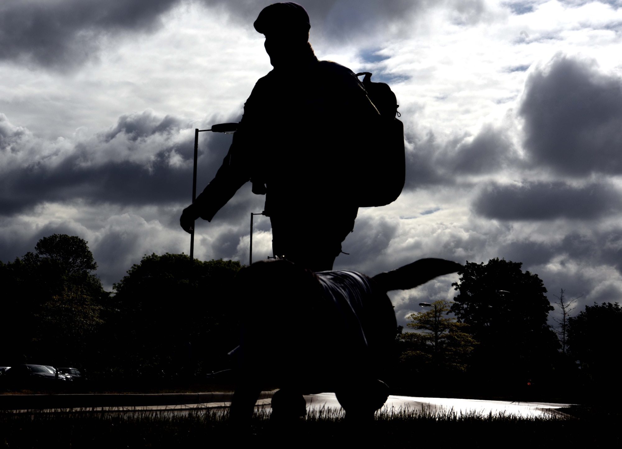 A 100th Security Forces Airman marches during the 100th SFS Memorial Ruck March as part of events to commemorate National Police Week at RAF Mildenhall, England, May 13, 2020. National Police Week is an observance in the United States which pays tribute to local, state and federal officers who’ve died or who’ve been disabled in the line of duty. (U.S. Air Force photo by Senior Airman Brandon Esau)