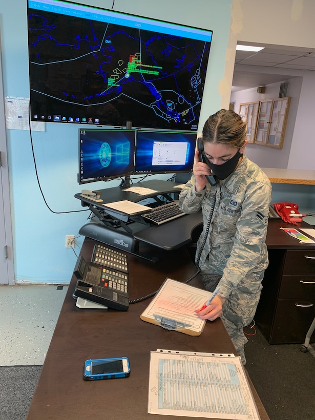 U.S. Air Force Airman 1st Class Leandra Ventura-Perez, 3rd Operations Support Squadron Airfield Management operations coordinator, communicates with an aircrew while wearing a protective facemask at Joint Base Elmendorf-Richardson, Alaska, April 23, 2020. Amid the COVID-19 outbreak, the 3rd OSS Airfield Management team has been adopting a “new normal” mentality as they operate in Health Protection Condition (HPCON) CHARLIE and incorporate protective measures to ensure the execution of JBER’s essential flying missions.