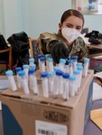 Georgia National Guard Spc. Illiana Bartsch of the Ft. Stewart-based 179th Military Police Company sorts test specimen vials at Delmar Gardens of Smyrna April 29, 2020. Bartsch is a member of a Georgia National Guard mobile testing strike team deployed to test senior citizens for COVID-19.