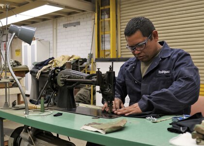U.S. Army Sgt. Edwin Rodriguez, a welder at the California National Guard's combined support maintenance shop, sews face masks for other Soldiers on a vintage sewing machine, April 23, 2020, inside the Long Beach, California, facility. Rodriguez found and repaired two of the shop's three vintage sewing machines before putting his civilian skills as a former upholstery technician to work sewing masks.