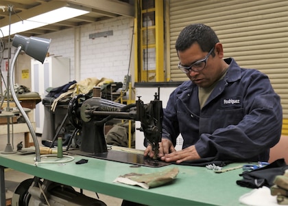 U.S. Army Sgt. Edwin Rodriguez, a welder at the California National Guard's combined support maintenance shop, sews face masks for other Soldiers on a vintage sewing machine, April 23, 2020, inside the Long Beach, California, facility. Rodriguez found and repaired two of the shop's three vintage sewing machines before putting his civilian skills as a former upholstery technician to work sewing masks.