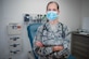 The 633rd Medical Operations Squadron family health flight commander, stands in an examination room.