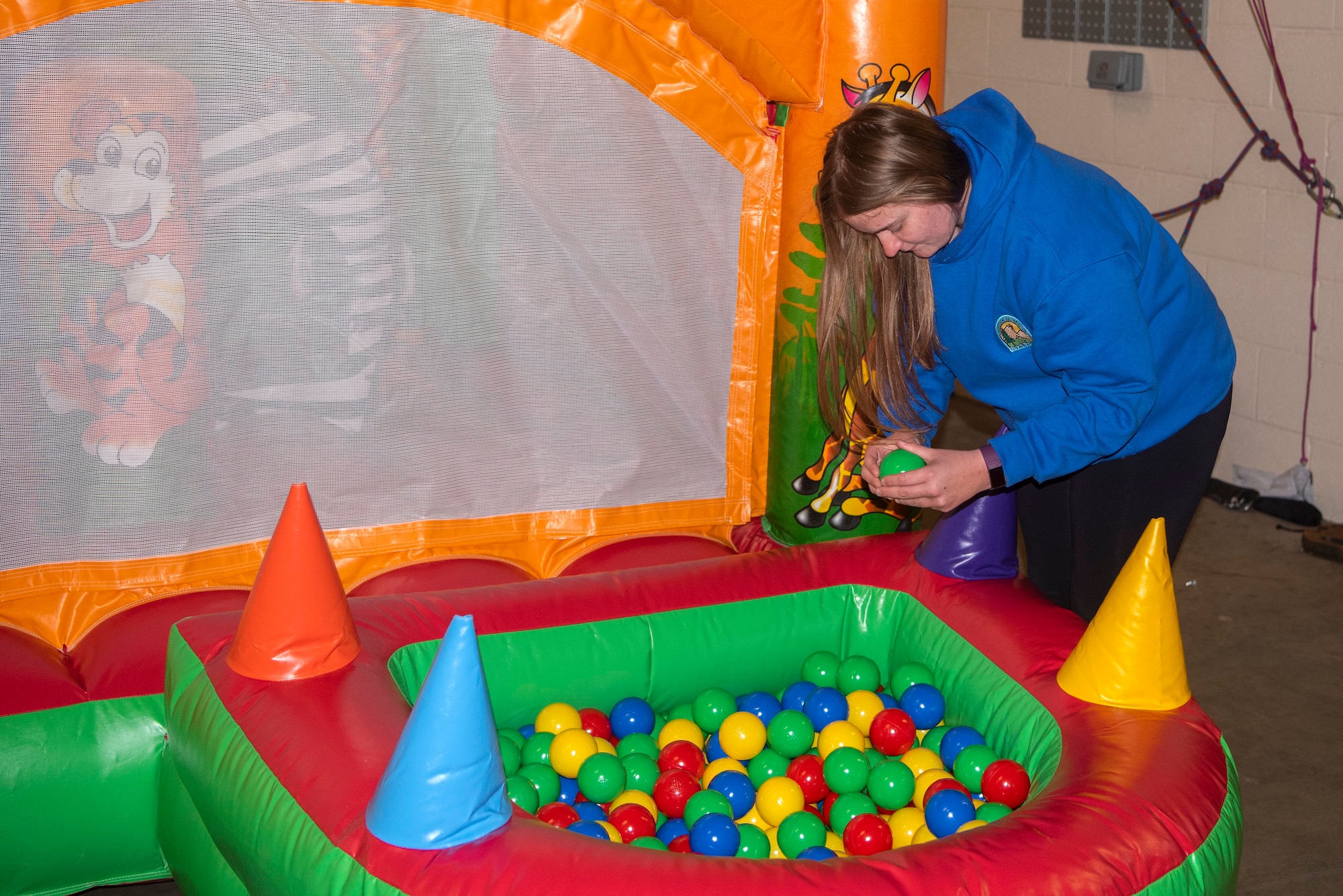 Kim Stonebridge, 100th Force Support Squadron outdoor recreation adventure programmer, inspects the condition of a newly  arrived bouncy castle, inside the outdoor recreation center at RAF Mildenhall, England, May 11, 2020. Although the center continues to rent out certain items like yard equipment, mountain bikes and outdoor games, items that facilitate gatherings of people are not available for rental during the COVID-19 lockdown. (U.S. Air Force photo by Airman 1st Class Joseph Barron)