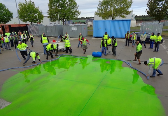Personnel apply absorbent rolls to a simulated hazardous material spill during a training scenario at U.S. Army Garrison Rheinland-Pfalz in 2019. U.S. Army Installation Management Command garrisons are more efficient and effective at management, tracking, and reporting of hazardous materials thanks to the Environmental, Safety and Occupational Health – Management Information System implementation team of Huntsville Center’s Environmental and Munitions Center of Expertise.