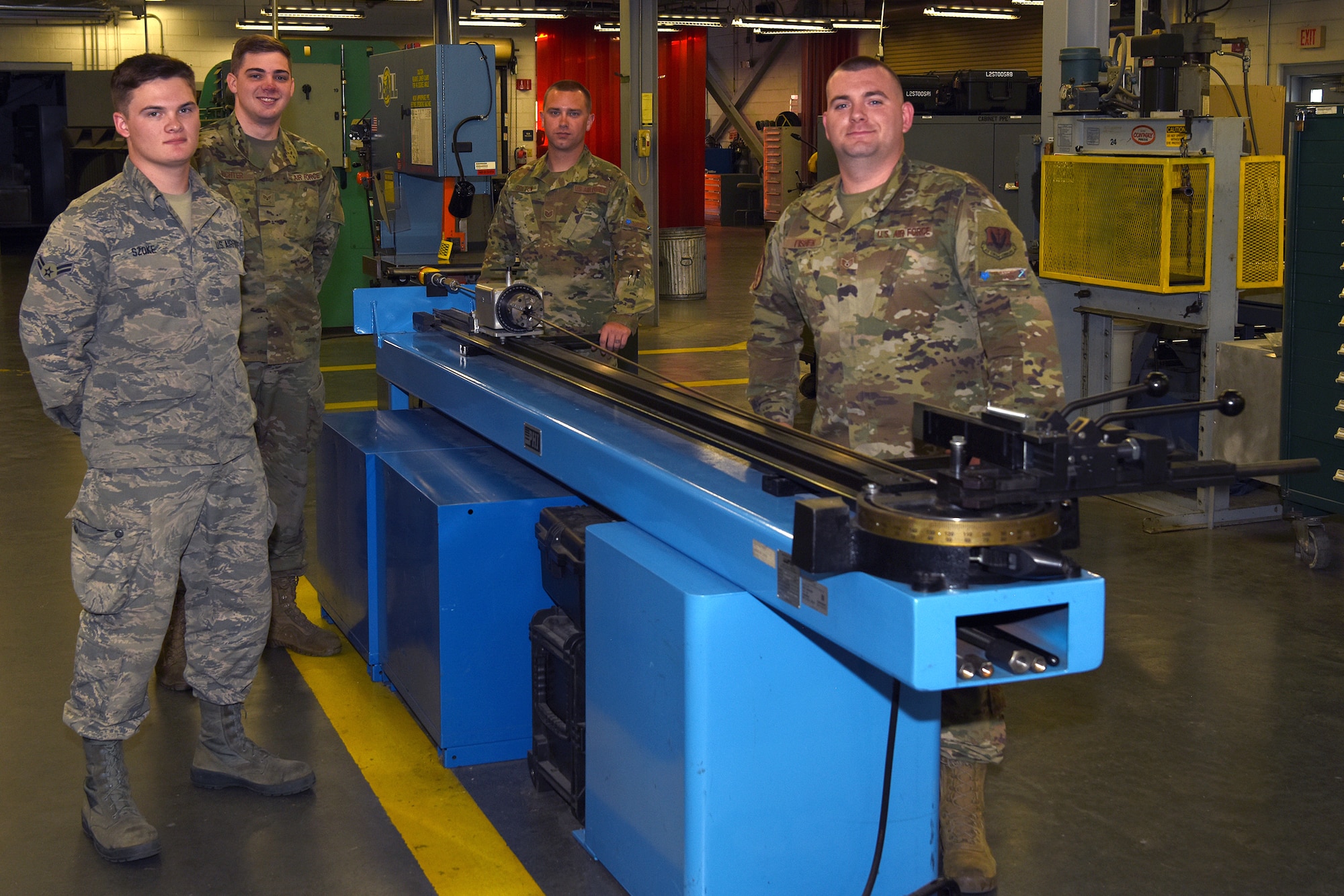 Pictured from left to right are Airman 1st Class Chase Szoke, Tech. Sgt. Austin Soltow, Staff Sgt. Michael Fisher and  Senior Airman Joseph Richter were part of a team who designed a commemorative tail flash on a Swamp Fox F-16 fighter jet with the tail number 911 to honor those who died during the terrorists attacks.