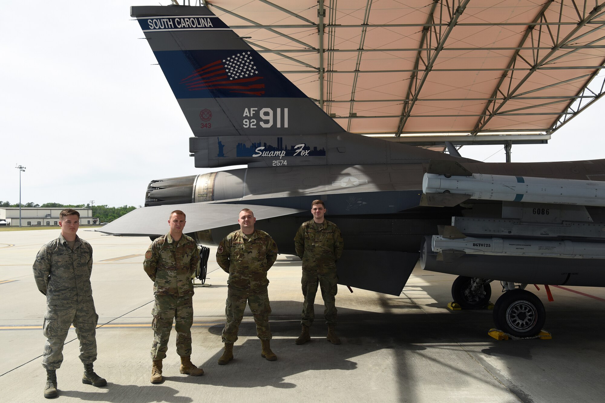 Pictured from left to right are Airman 1st Class Chase Szoke, Tech. Sgt. Austin Soltow, Staff Sgt. Michael Fisher and  Senior Airman Joseph Richter were part of a team who designed a commemorative tail flash on a Swamp Fox F-16 fighter jet with the tail number 911 to honor those who died during the terrorists attacks.