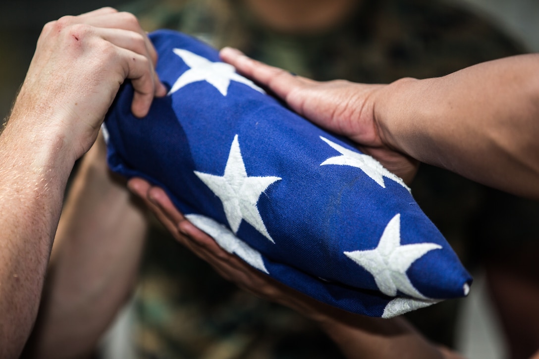 U.S. Marines fold the national flag during honor guard practice at 13 Area Maintenance, Marine Corps Base Camp Pendleton, California, May 22.
