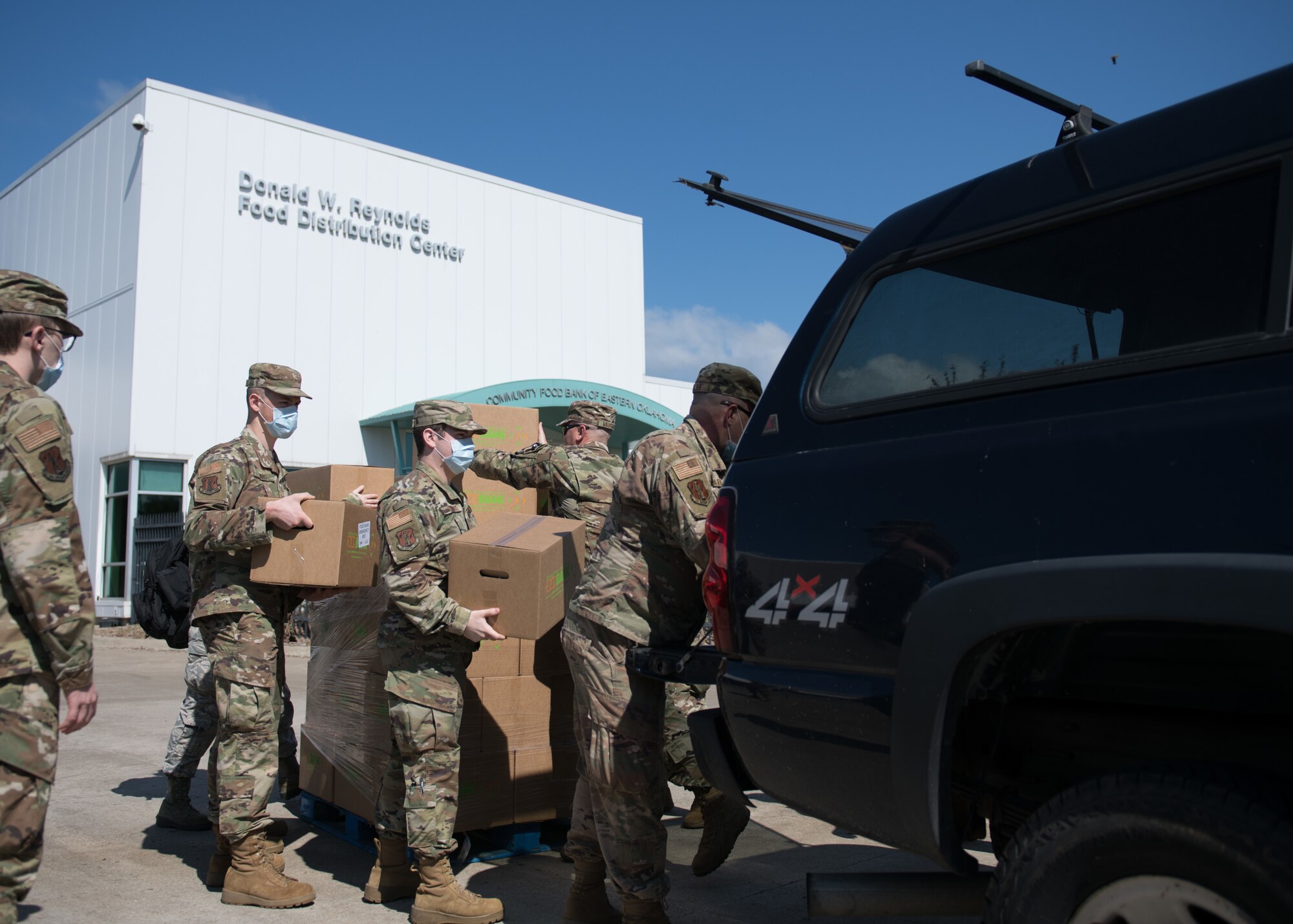 Airmen from the 138th Fighter Wing, Oklahoma Air National Guard, load boxes of food to be delivered at the Community Food Bank of Eastern Oklahoma in Tulsa, Oklahoma, April 23, 2020. Twenty five Airmen from the 138th FW are working with the food bank to provide support including receiving, packing and transporting food, as well as completing inventories of food bank supplies. At the direction and authorization of Oklahoma Governor Kevin Stitt, Oklahoma Guardsmen were activated to serve in various roles in support of the State's COVID-19 response (U.S. Air National Guard photo by Tech. Sgt. Rebecca Imwalle)