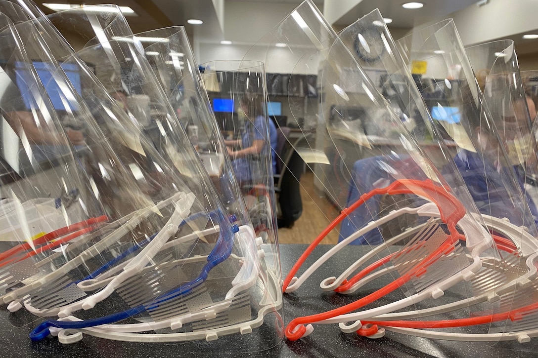 Face shields stacked on a table.