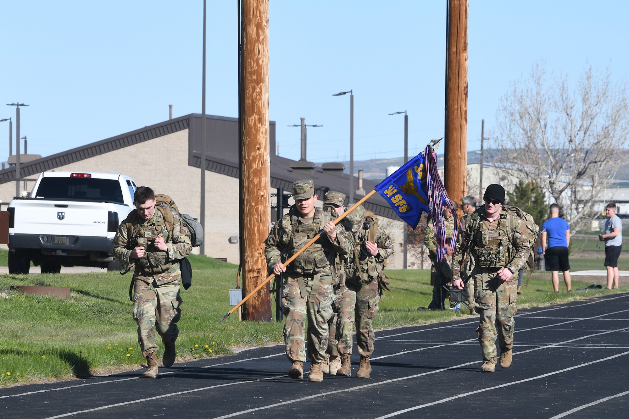 Airmen take part in a ruck march in honor of fallen defenders May 14, 2020, at Malmstrom Air Force Base, Mont.