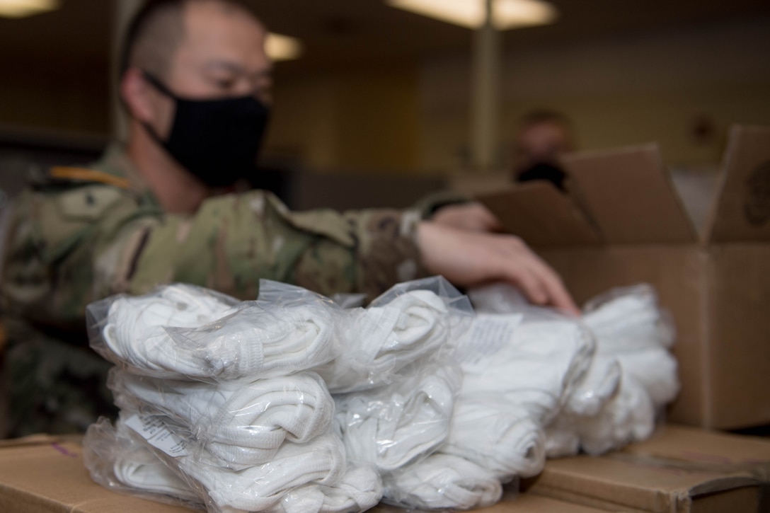U.S. Army Staff Sgt. Nicolas Chang, 128th Aviation Brigade, Headquarters and Headquarters Company senior supply sergeant, counts face mask at Joint Base Langley-Eustis, Virginia, May 13, 2020. According to guidelines in combating COVID-19, face mask and social distancing is the best way to limit exposure to the virus. (U.S. Air Force photo by Senior Airman Derek Seifert)