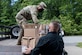 U.S. Army Staff Sgt. Nicolas Chang, 128th Aviation Brigade, Headquarters and Headquarters Company senior supply sergeant, and Josh Howe, Central Issue Facility supply technician, load boxes of face mask onto a truck at Joint Base Langley-Eustis, Virginia, May 13, 2020. The cost of each mask is $0.24 and 7.5 million were donated to the U.S. Army by a commercial vendor. (U.S. Air Force photo by Senior Airman Derek Seifert)