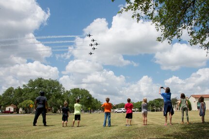 Children from the Joint Base San Antonio-Randolph School Age Program watch as the U.S. Air Force Air Demonstration Squadron, the Thunderbirds, fly over the Taj Mahal during their America Strong salute, at JBSA-Randolph May 13.