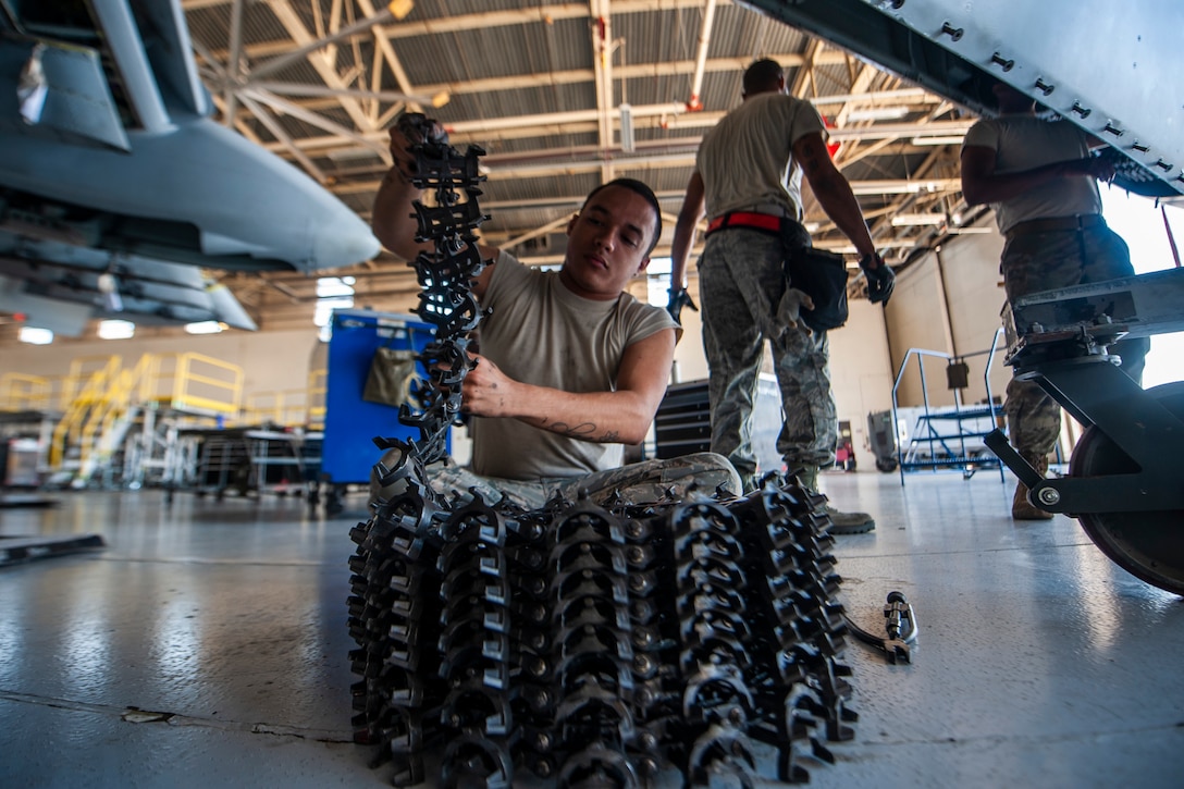 A photo of an Airman removing a chain from an A-10