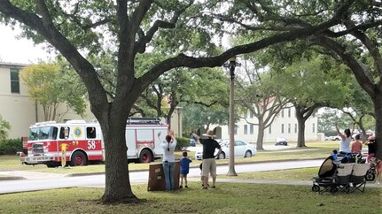 The lead vehicle of the procession during the National Police Week parade drives through base housing at Joint Base San Antonio-Randolph, Texas, May 13, 2020, as spectators cheer and show appreciation for security forces, fire department and medical team members. Due to COVID-19 and social distancing, the 902nd Security Forces Squadron invited other first responders to join them in the parade through base housing so the community could show their appreciation.