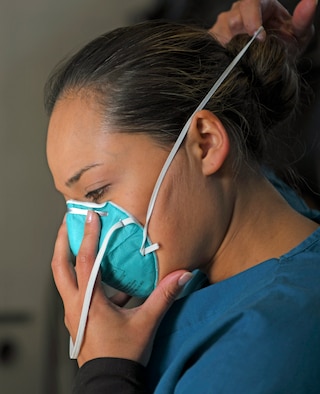 Woman putting on mask