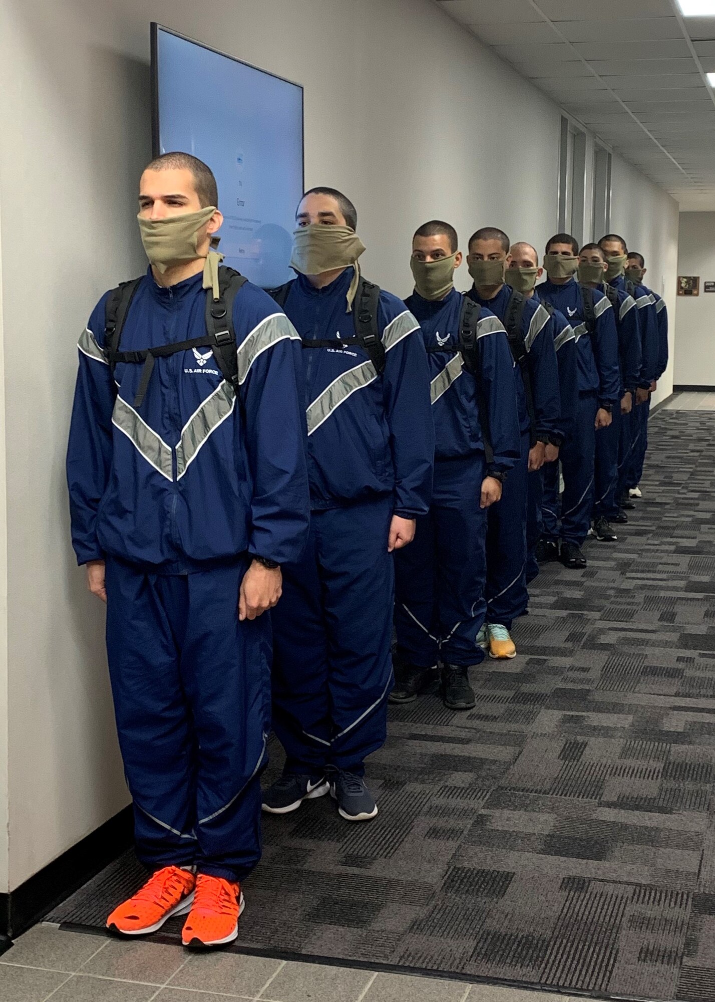 US Air Force Echo Flight trainees stand in line in the halls of DLIELC. They came to campus in person to take their placement English Comprehension Level placement exam. They will be attending their English learning classes via distance learning from the 737 TRSS learning lab.