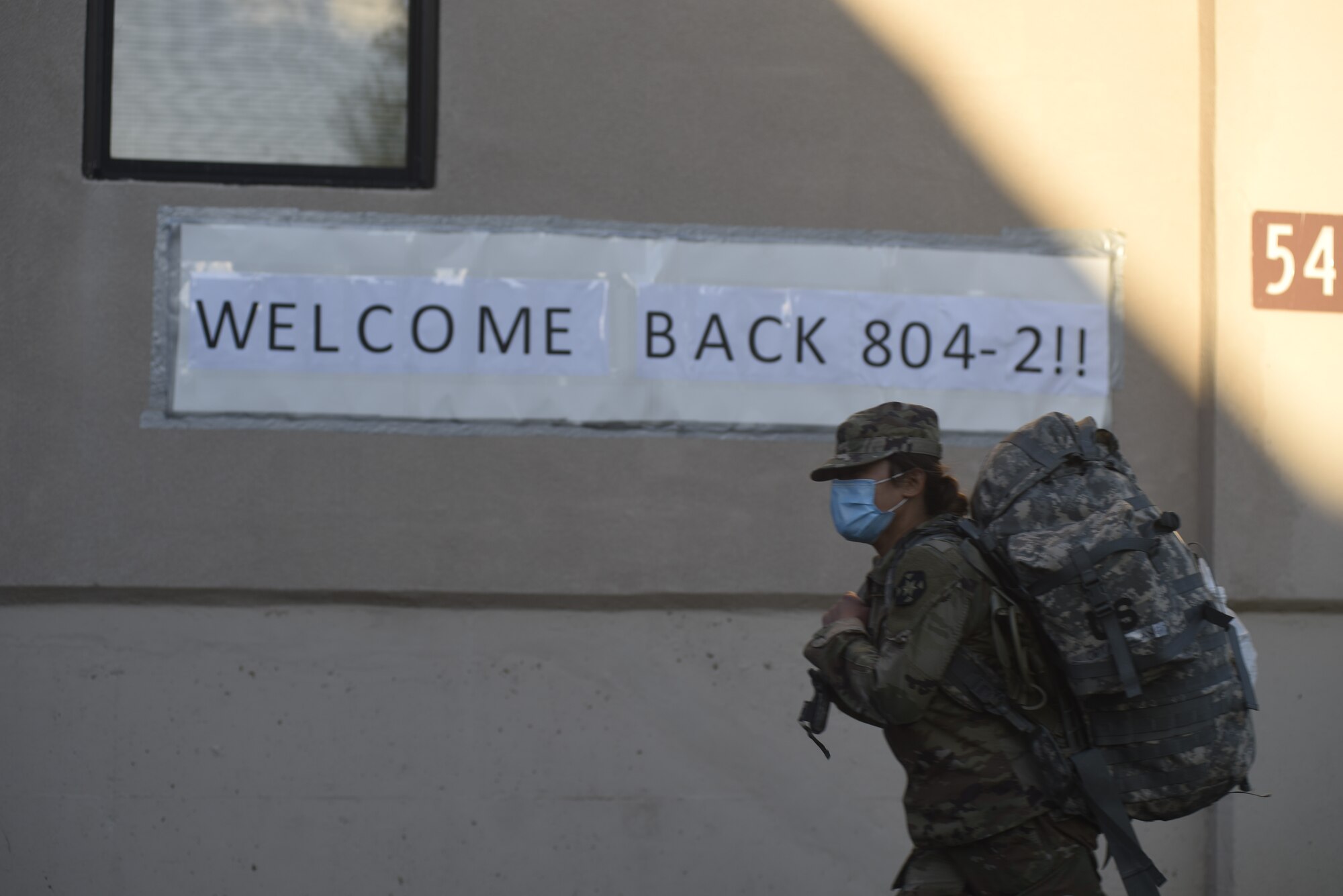 Photo of a soldier walking with a backpack.