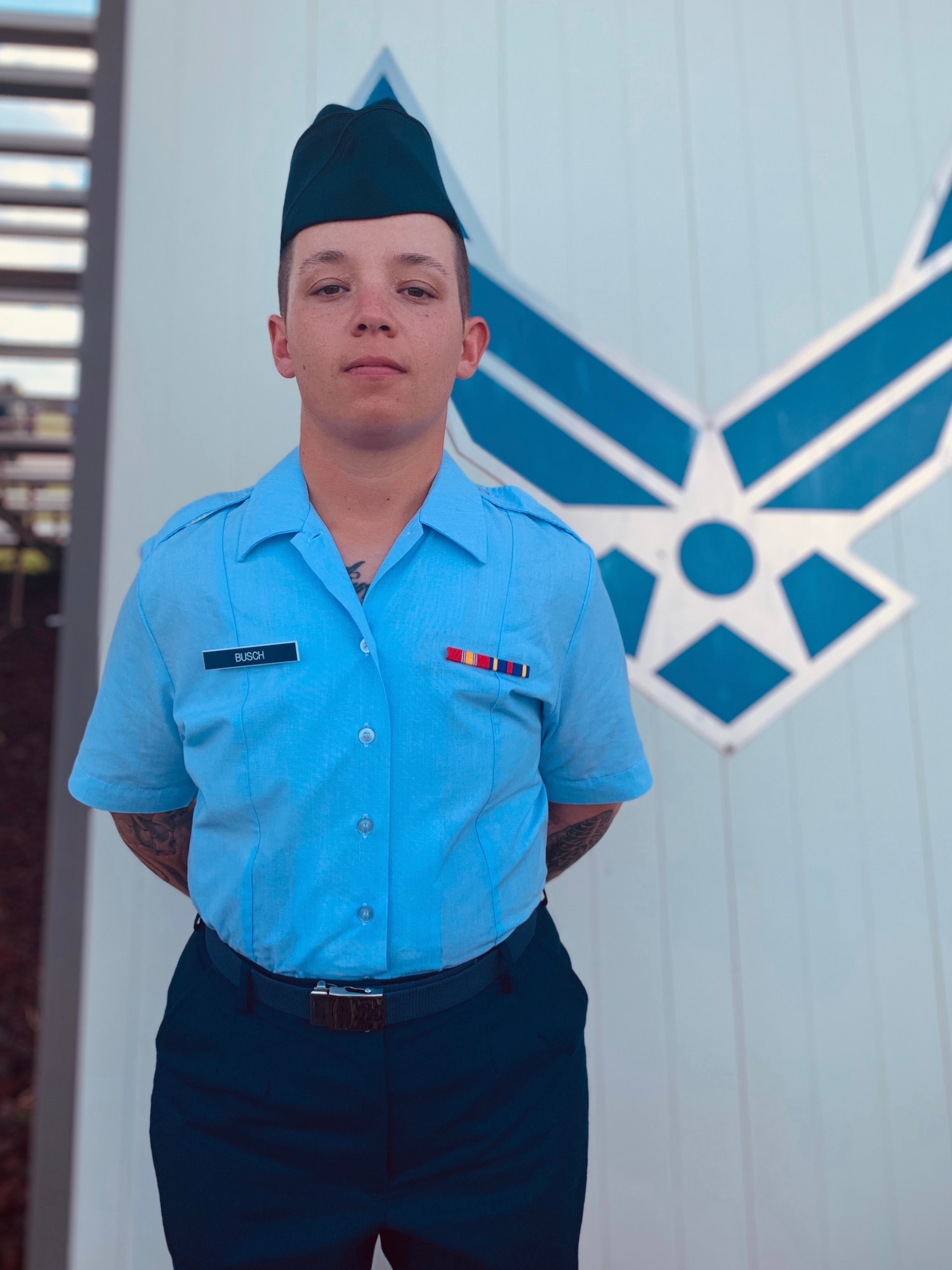 Airman Shannon Busch stands holding an award. (Courtesy Photo)