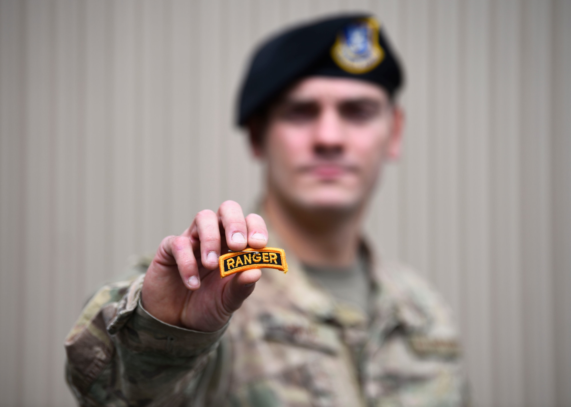 U.S. Air Force Staff Sgt. Joseph Pace, 92nd Security Forces Squadron installation patrolman, holds his Ranger tab at Fairchild Air Force Base, Washington, May 7, 2020. Pace completed the grueling 62 day course in April after starting in November 2019. (U.S. Air Force phot by Senior Airman Lawrence Sena)