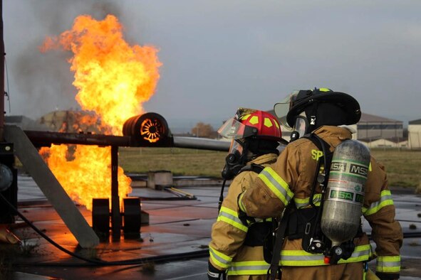U.S. Air Force Staff Sgt. Adrianna Hopkins, 312th Training Squadron instructor, Goodfellow Air Force Base, Texas, and Senior Airman Christian Hibner, 7th Civil Engineer Squadron firefighter, Dyess AFB, Texas, participate in a burn exercise at Spangdahlem AB, Germany, October, 2018. The 52nd FES Airmen stay mission ready through the COVID-19 pandemic with consistent training to maintain their ability to respond to an emergency at a moment’s notice. (Photo courtesy of Senior Airman Sean Howley)