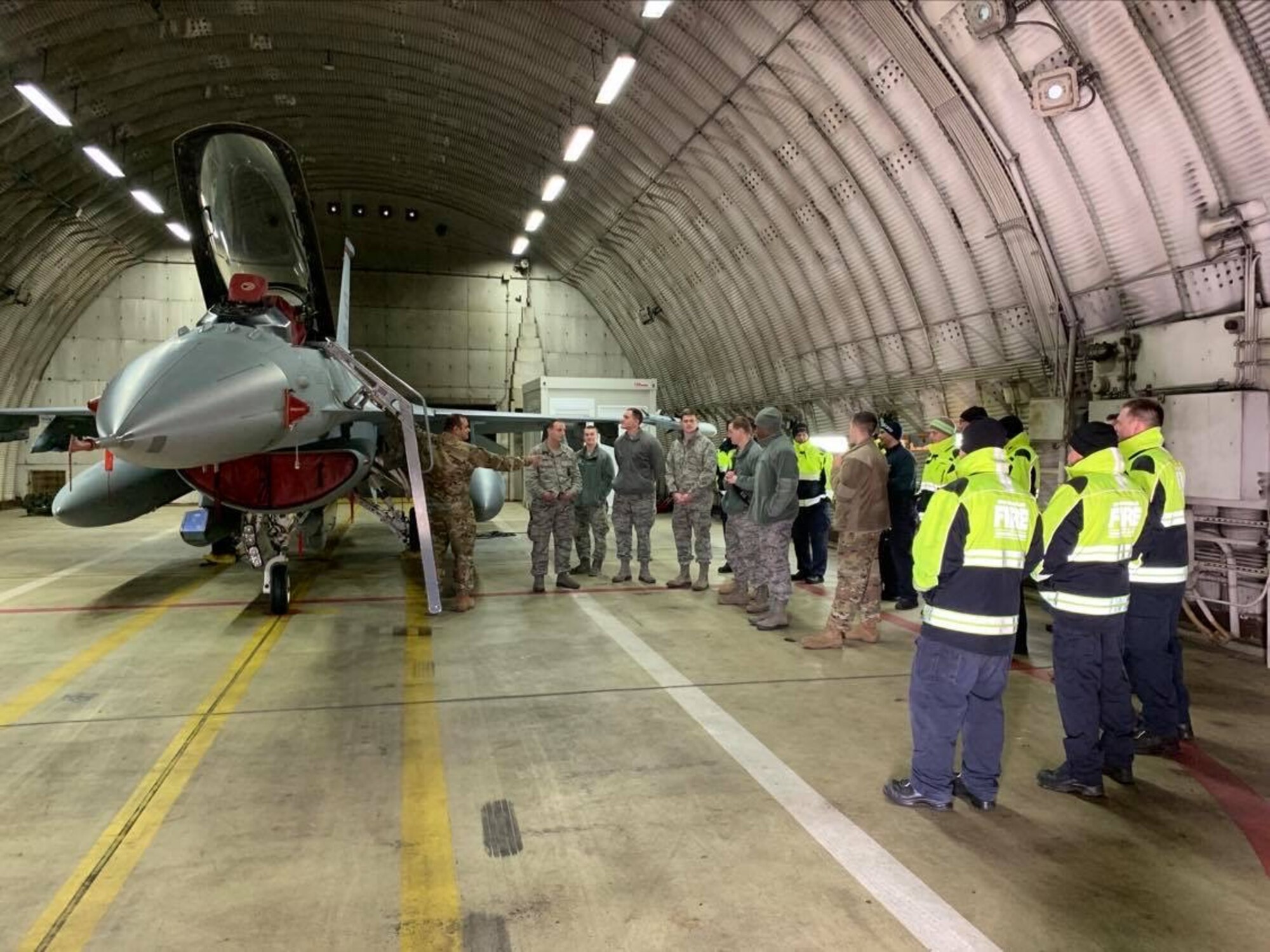 Members of the Spangdahlem Fire Department conduct training alongside host nation civilian contractors with an F-16 Fighting Falcon at Spangdahlem Air Base, Germany, February 11, 2020. The Spangdahlem Fire Department stays mission ready during the COVID-19 pandemic through continuation of training with host nation civilian contractors and maintaining their ability to respond to emergencies at a moment’s notice. (Photo courtesy of the Spangdahlem Fire Department)