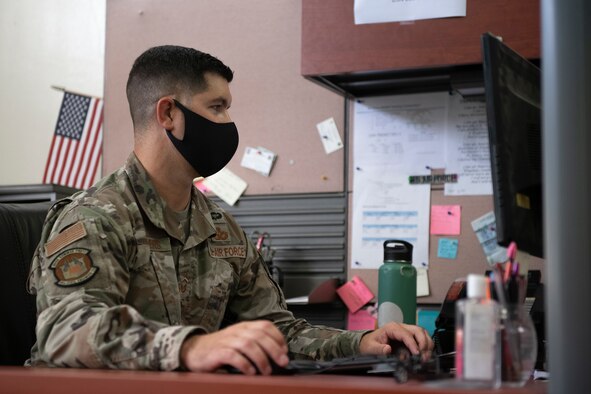 U.S. Air Force Master Sgt. Andrew Sanders, Future Operations team member from the 18th Civil Engineer Squadron, coordinates COVID-19 data with U.S. Forces Japan teams at an emergency operations center May 13, 2020, at Kadena Air Base, Japan. Sanders works with members from other squadrons and together they make up a diverse group of subject matter experts who develop counter-COVID-19 solutions for a variety of potential issues that could impact Team Kadena during the pandemic. (U.S. Air Force photo by Staff Sgt. Peter Reft)