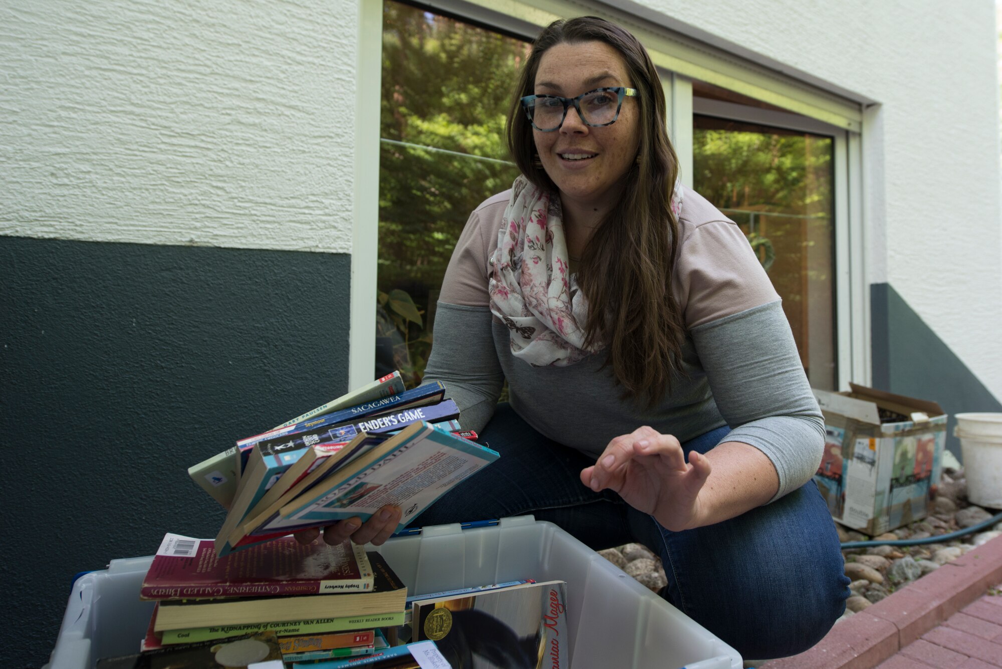 A photo of a teacher sorting through books.