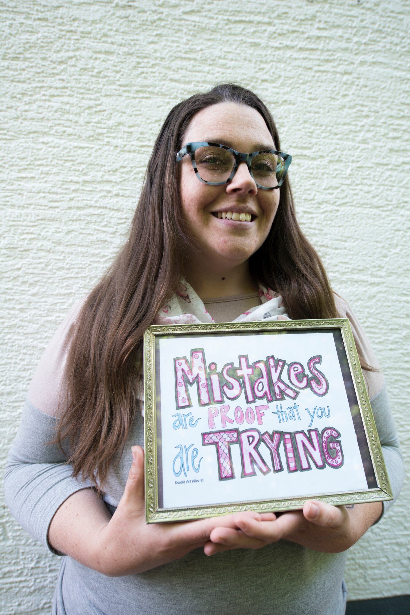 A photo of a teacher posing for a photo.