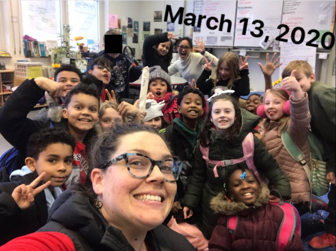 A photo of a teacher with her students.