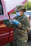 Sgt. Alondra Morales, assigned to the 1452nd HET Transportation Company, uses her bilingual capabilities to help communicate with fellow citizens during food distribution at the Second Harvest Food Bank in Winston-Salem, N.C., May 9, 2020. The NCNG has helped deliver about 1 million meals and 73,000 school lunches across the state.