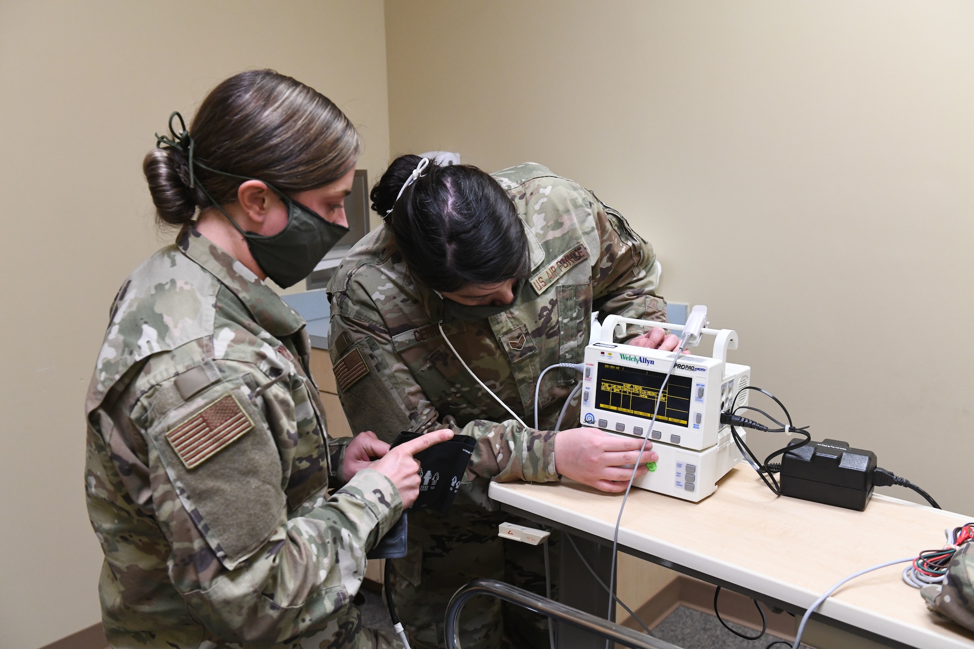 U.S. Air Force Senior Airman Marissa Cerra (right) practices checking an incoming patient for fever and abnormal health while conducting drills prior to accepting live patients, at the North Carolina National Guard Medical Support Shelter (MSS), Central North Carolina, April 29, 2020. The MSS is intended to act as an overflow shelter for hospital patients not infected with the COVID-19 virus and is maned by a joint task force of Army and Airforce National Guard medical staff.