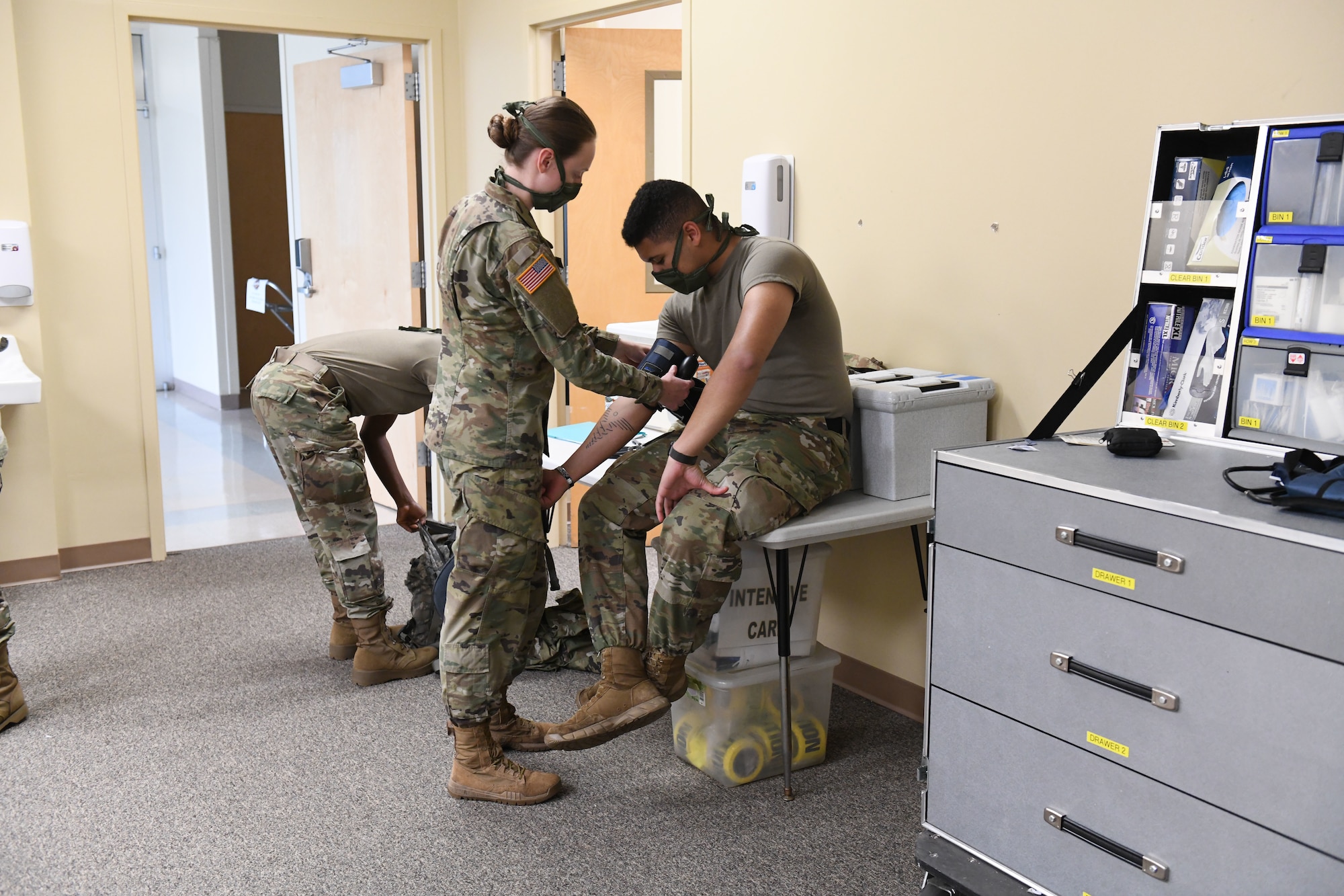 North Carolina Army and Air National Guard medical technicians practice working with a blood pressure monitor, while conducting drills prior to the arrival of live patients, at the North Carolina National Guard Medical Support Shelter (MSS), Central North Carolina, April 30, 2020. The MSS is intended to act as an overflow shelter for hospital patients not infected with the COVID-19 virus and is maned by a joint task force of Army and Airforce National Guard medical staff.