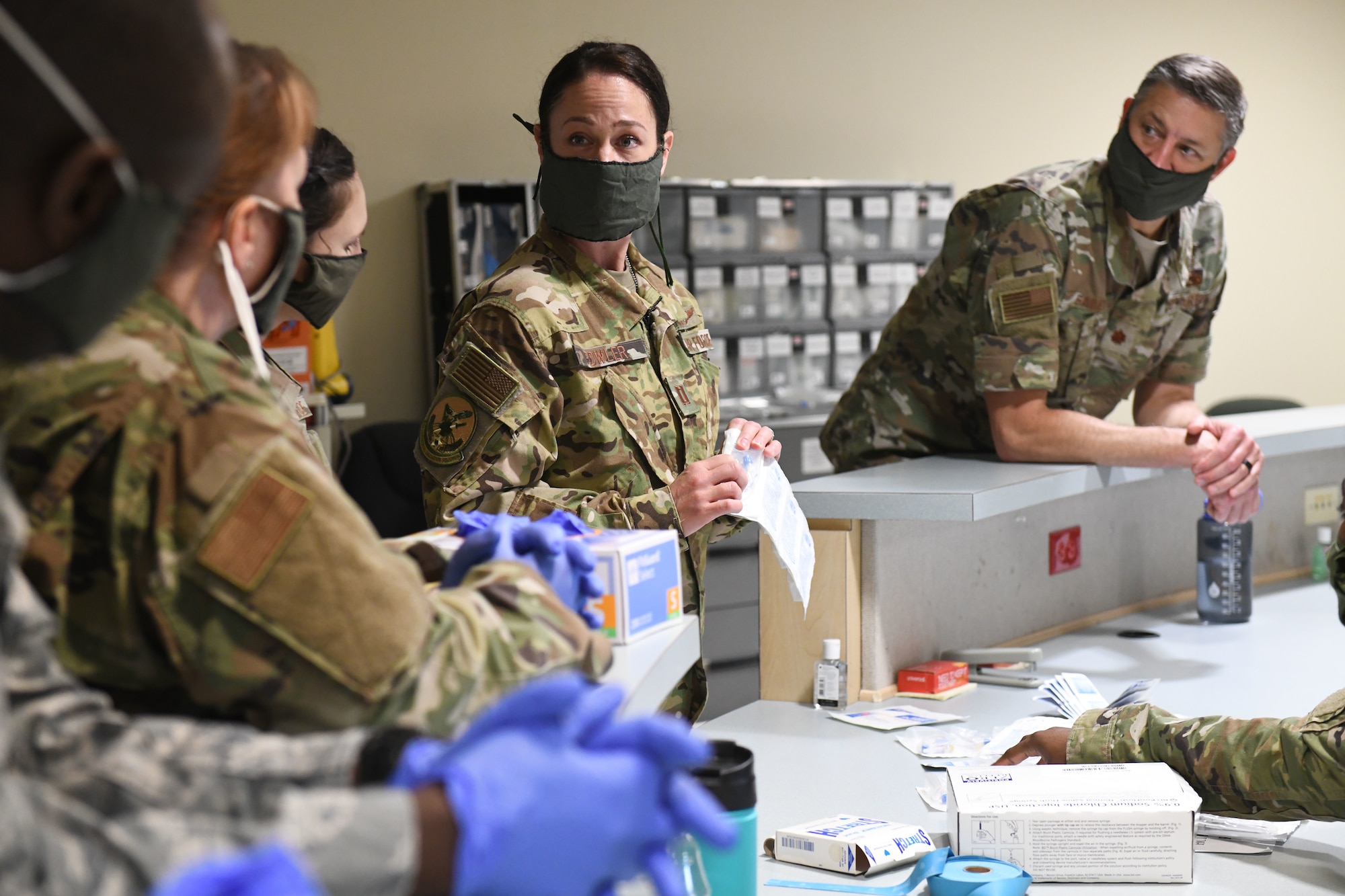 Medical technicians with the North Carolina Army and Air National Guard prepare to practice sticking IV needles in order to prepare for the possible arrival  of potential patients, while at the North Carolina National Guard Medical Support Shelter (MSS), Central North Carolina, April 30, 2020. The MSS is intended to act as an overflow shelter for hospital patients not infected with the COVID-19 virus and is maned by a joint task force of Army and Airforce National Guard medical staff.