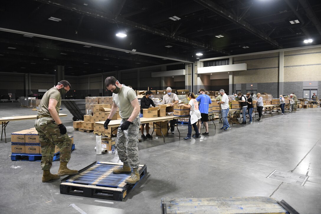 Members of the 145th Airlift Wing assist the Charlotte Metrolina Food Bank by helping to transport supplies and box food packages for North Carolina citizens in need.