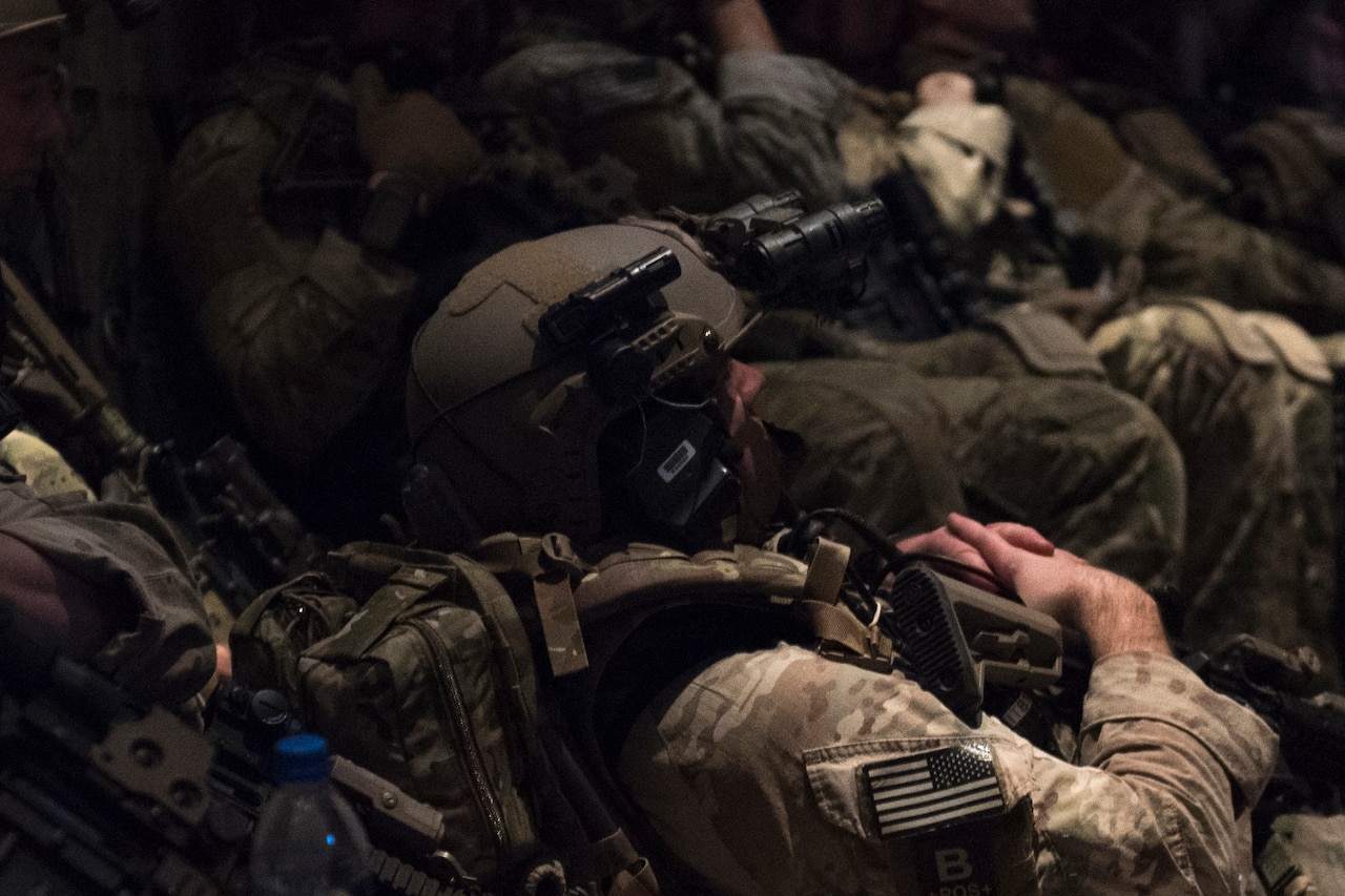 Airmen sit in a C-130.