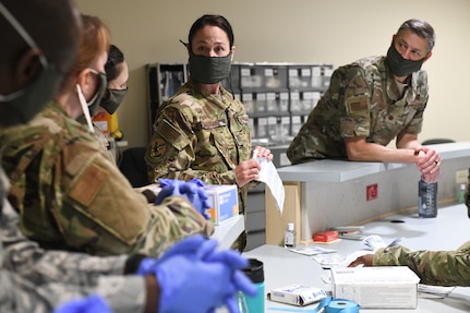 Medical technicians with the North Carolina Army and Air National Guard prepare to practice sticking IV needles in preparation for the possible arrival  of patients at the North Carolina National Guard medical support shelter in central North Carolina, April 30, 2020.