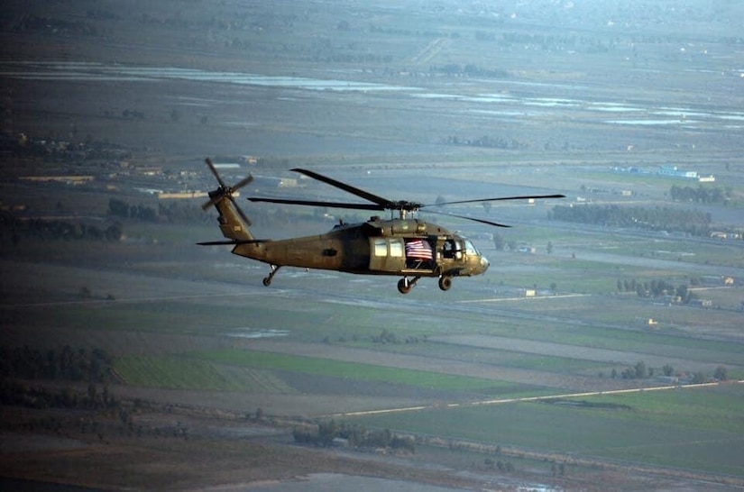 Chief Warrant Officer 4 Joval Eblen III, 1st Battalion, 228th Aviation Regiment pilot, flies a UH-60 Blackhawk helicopter with his personal American flag over Iraq.