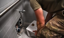 Senior Airman Logan Smith, 628th Civil Engineering Squadron water and fuels systems maintenance specialist, performs plumbing maintenance on Joint Base Charleston, S.C., May 12, 2020. Water and fuel systems maintenance specialists manage the plumbing, wastewater collection systems, liquid fuel storage and natural gas distribution systems on every base. This maintenance can include the waste systems that keep bases clean and sanitary. Water and fuel system maintainers have kept up operations during the COVID-19 physical distancing posture in order to ensure base cleanliness and the health and wellness of our JB Charleston teammates.