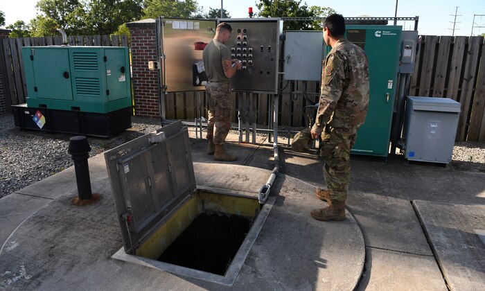 Senior Airman Logan Smith, left, and Staff Sgt. Roman Guenther, right, 628th Civil Engineering Squadron water and fuels systems maintenance specialists, perform maintenance on a septic pump system on Joint Base Charleston, S.C., May 12, 2020. Water and fuel systems maintenance specialists manage the plumbing, wastewater collection systems, liquid fuel storage and natural gas distribution systems on every base. This maintenance can include the waste systems that keep bases clean and sanitary. Water and fuel system maintainers have kept up operations during the COVID-19 physical distancing posture in order to ensure base cleanliness and the health and wellness of our JB Charleston teammates.