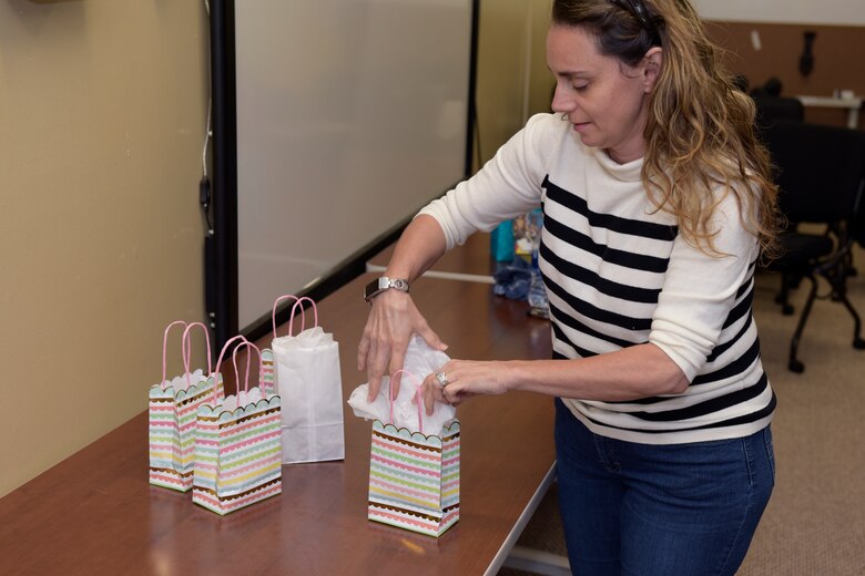 17th Training Wing Violence Prevention Integrator, Donna Casey, prepares packages for Military Training Leaders in the Adopt-An-MTL program by packing gift bags at the Violence Prevention building, Goodfellow Air Force Base, Texas, May 1, 2020. The Adopt-An-MTL program was created to let Goodfellow MTLs know they are not alone during the COVID-19 pandemic. (U.S. Air Force photo by Senior Airman Zachary Chapman)