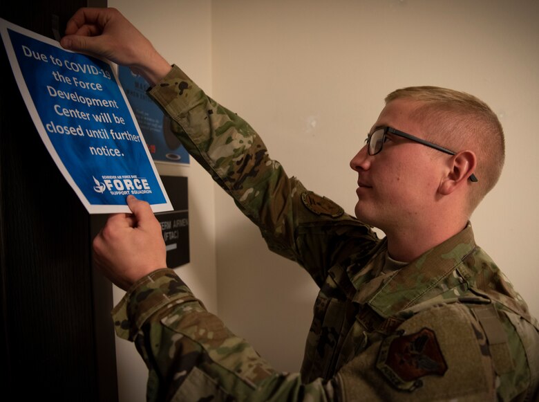 The 50th Force Support Squadron First Term Airman’s Course noncommissioned officer in charge, hangs a sign on the Force Development Center door at Schriever Air Force Base, Colorado, May 14, 2020. The 50th FSS FTAC team helped create a virtual FTAC course that is being used across the Air Force. (U.S. Air Force photo by Airman 1st Class Jonathan Whitely)
