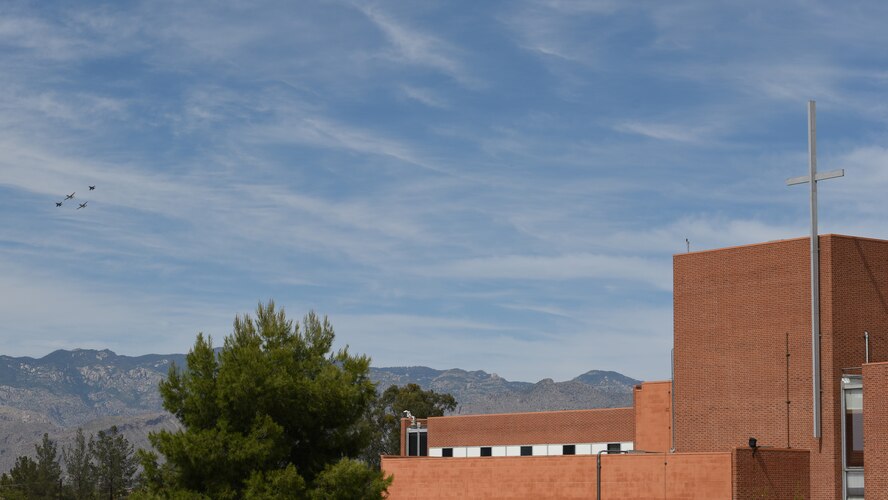 A photo of a four-ship formation performing a flyover.