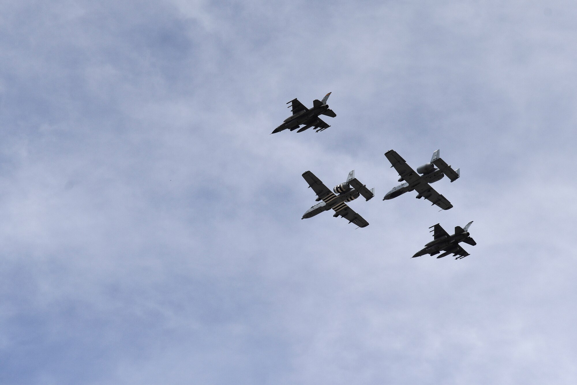 A photo a four-ship formation performing a flyover.