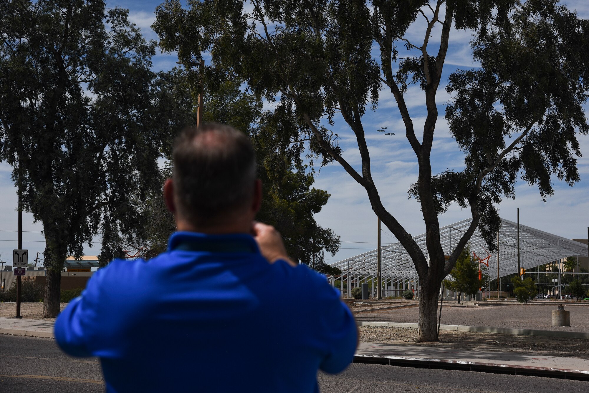 A photo of a civilian watching a flyover.